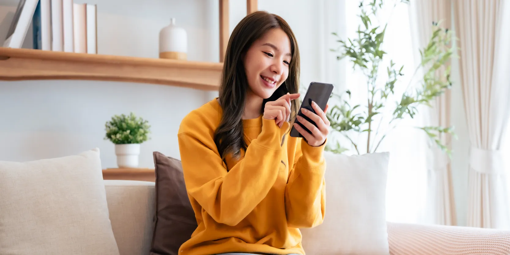 Pay Your Bills Online - woman on phone in living room