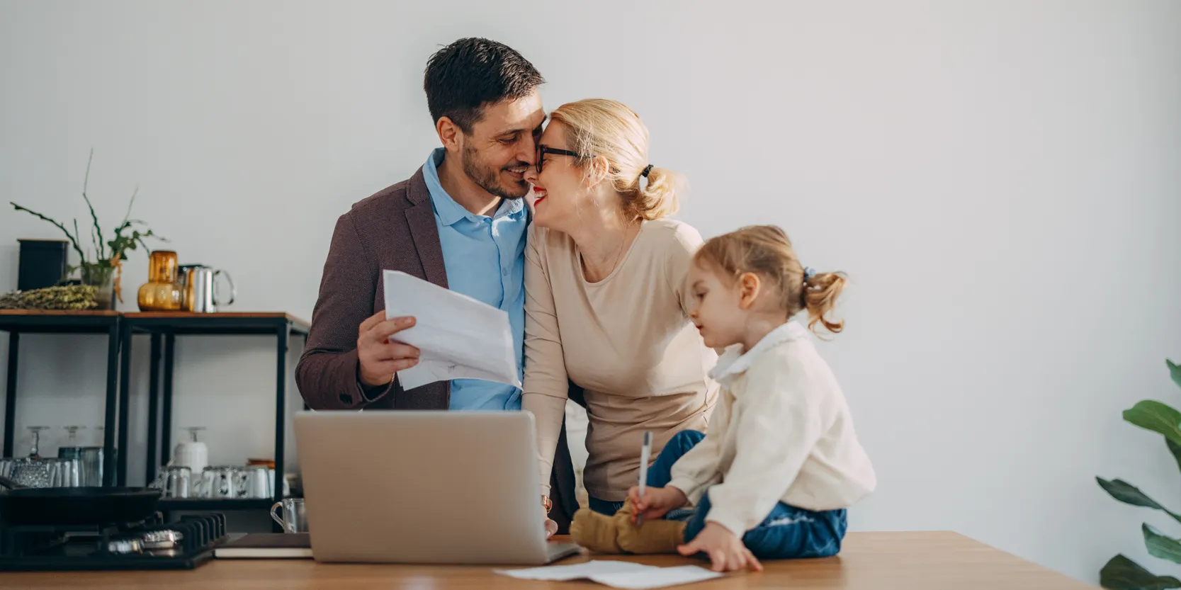 Credit Freeze FAQs - Family laughing together while working on a computer