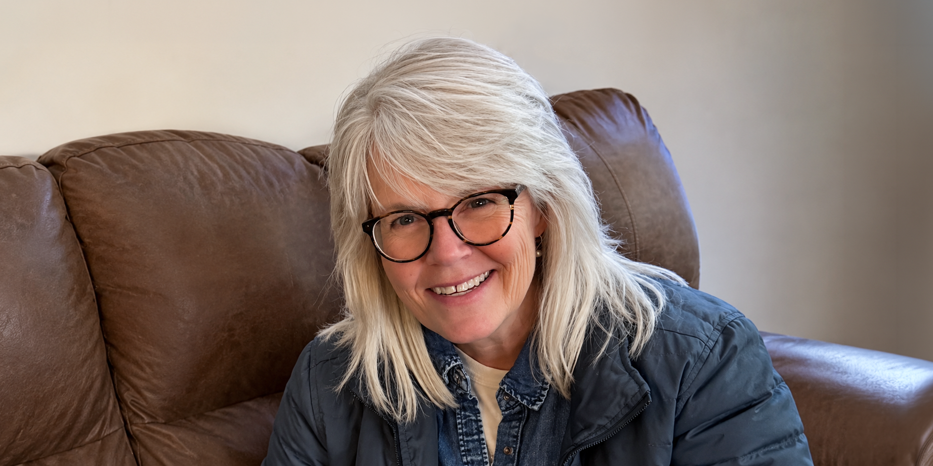 From the Core - Susanna sitting on a couch smiling at the camera