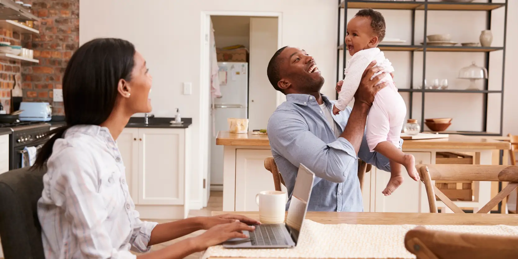 Dad holding son while mom watches